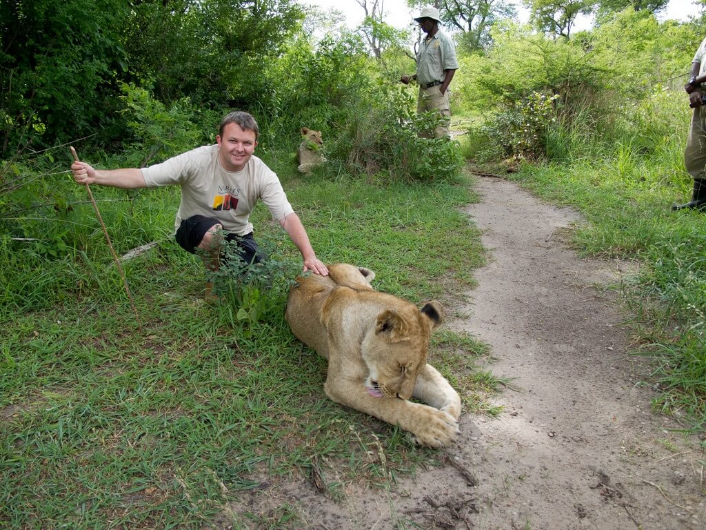 Hombre junto a un león en Zambia